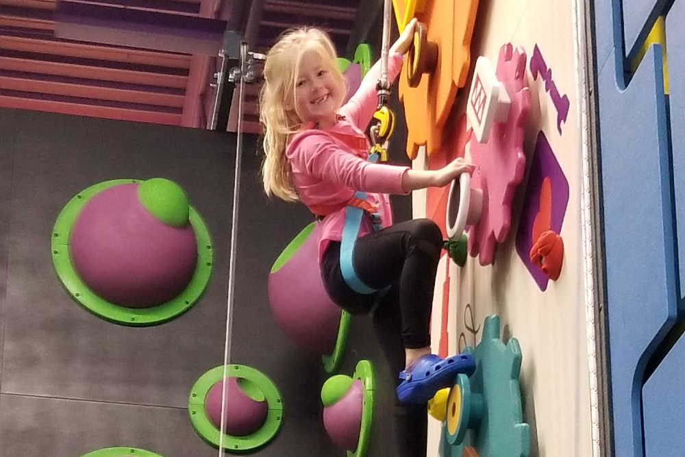 Young Girl On Climbing Wall