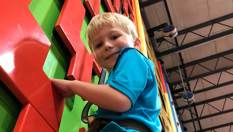 Boy On Climbing Wall