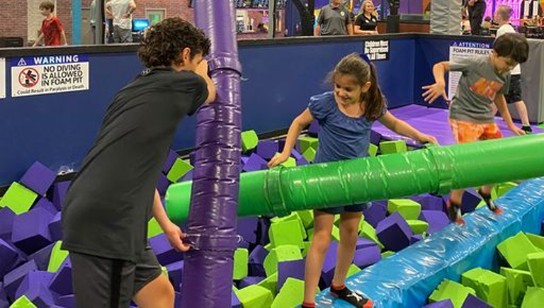 Kids Playing Trampoline Joust Battle